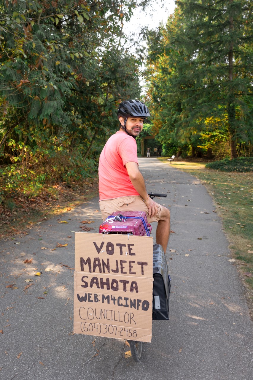 Manjeet Sahota biking and campaigning for Councillor